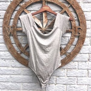 Grey body suit with open cross-cross back